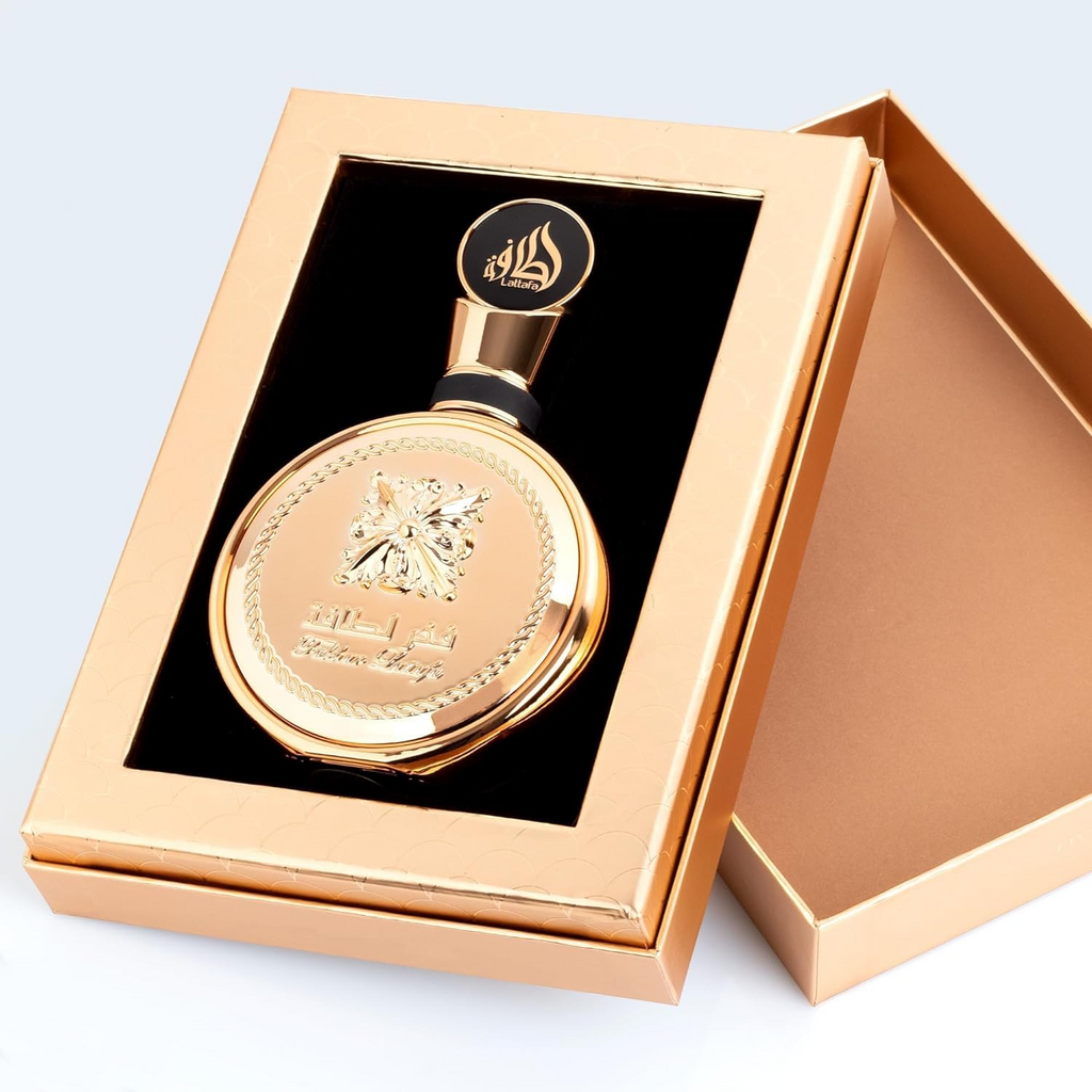 Lattafa Fakhar Gold Eau de Parfum 100ml bottle with gold accents, elegant packaging, and floral and woody fragrance details.