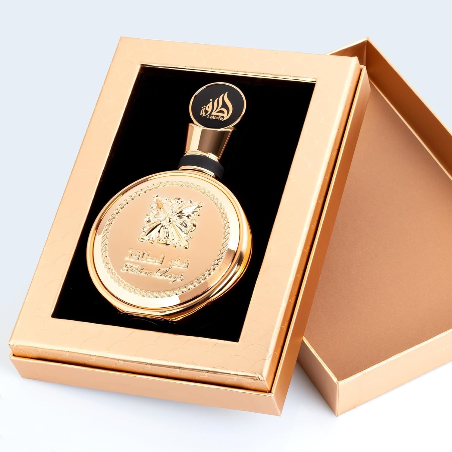 Lattafa Fakhar Gold Eau de Parfum 100ml bottle with gold accents, elegant packaging, and floral and woody fragrance details.