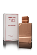 Al Haramain Amber Oud Eau De Parfum tester bottle with gold cap and amber-colored liquid, displayed on a plain background.
